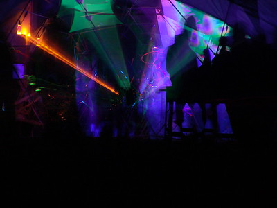Going back to my first encounter with fire spinners, later that evening, I was thinking about patterns and light designs as I wandered into the dance area where dancers were spinning balls with colored lights. I set up my tripod and tried to capture those, mostly with disappointing results because the dancers were moving so fast and the colored lights are much dimmer than flames.  However, while I was doing that, bombarded by very loud techno music, it occurred to me to use the zoom during a long exposure (30 seconds at f8):  "Zooming pattern".  The disadvantage of such long exposure is that the people who were dancing have disappeared.  The advantage is that without a bright fire, the colors become clear and interesting.