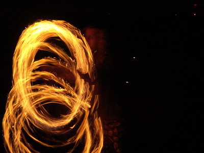When I saw my first fire performance show in 2005 at our local regional burning man event, Interfuse, I knew I had to capture the moving flames in a photograph.   It seemed obvious to me that I would need a tripod and a long exposure, and since I had a sturdy tripod with me, I made some pictures.  

The second fire spinning picture I took, "Spinner", was a four second exposure at f8.  The clarity of the flames and their pattern is very interesting, perhaps even more interesting than the blur of live action. But somehow the ghostly image of the person doing the spinning didn't seem to fit into the design as well as the impression of what I saw with my eyes.